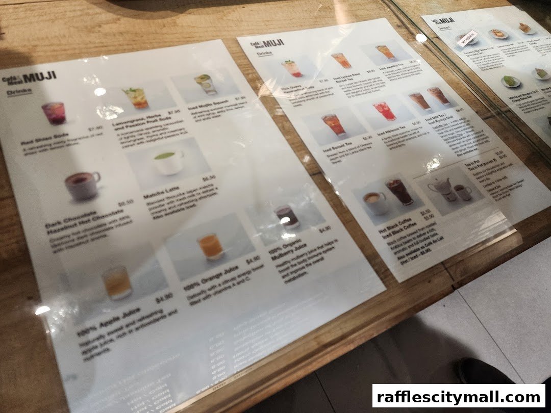 A menu from CafeMeal MUJI Raffles City displaying various drinks and desserts.