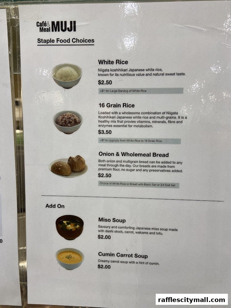 A menu from CafeMeal MUJI Raffles City featuring staple food choices and add-ons.