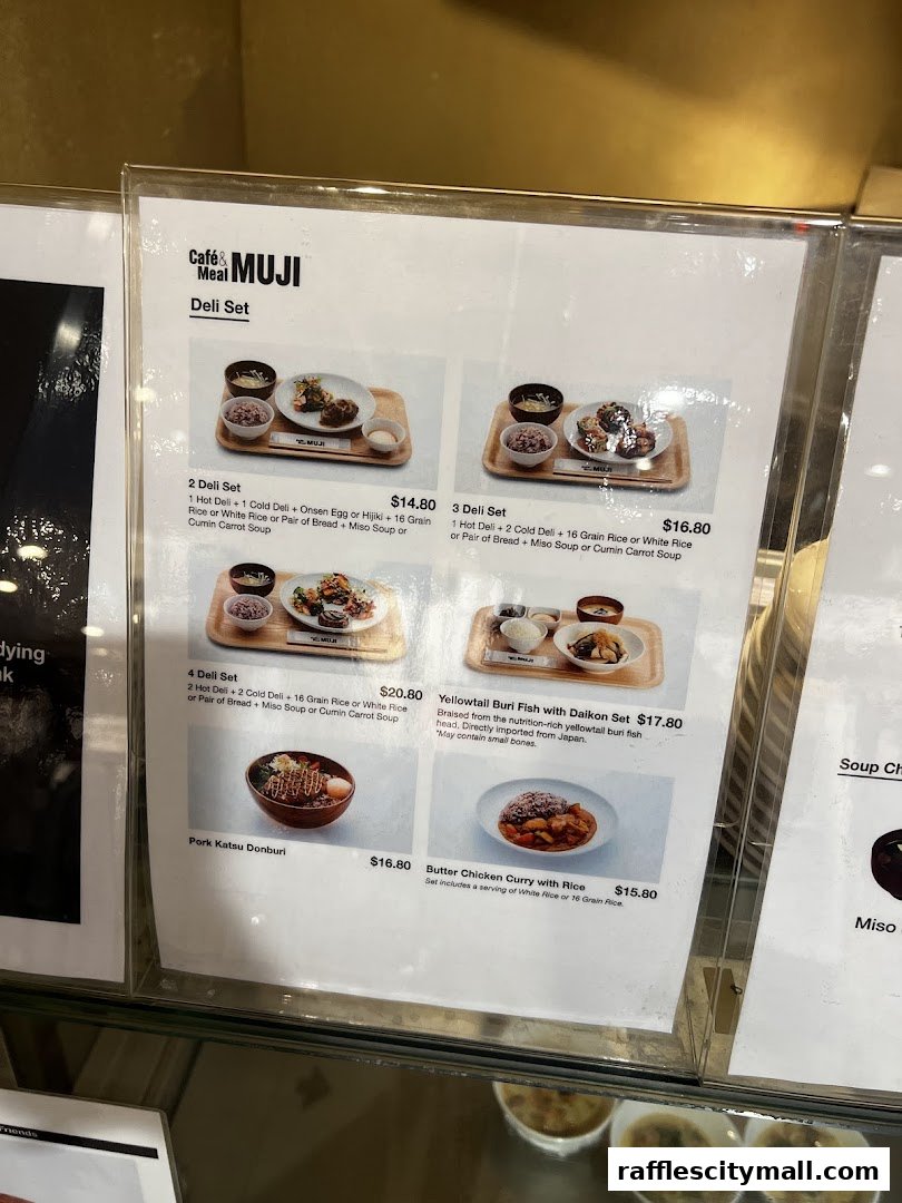 A menu from CafeMeal MUJI Raffles City showcasing various deli sets and main dishes.