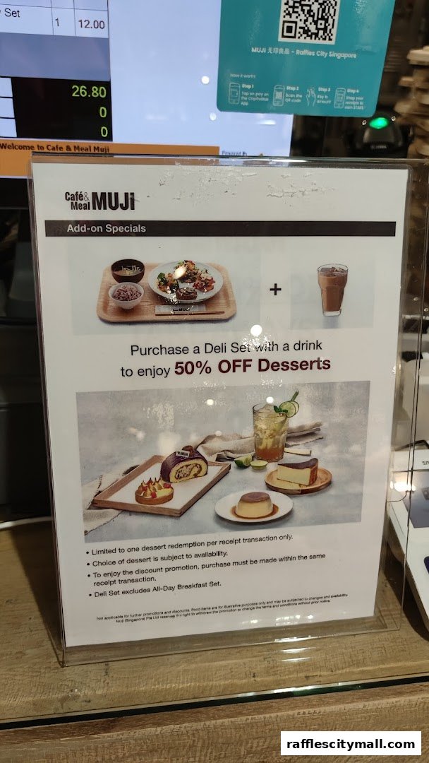 A promotional sign for Cafe & Meal MUJI offering 50% off desserts with a Deli Set purchase.