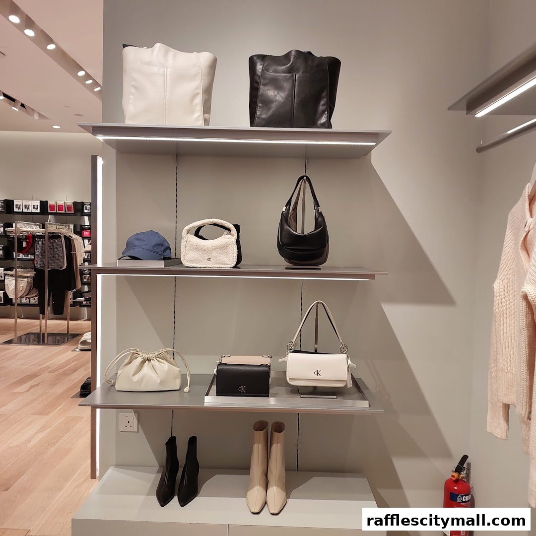 Calvin Klein store interior showcasing handbags, shoes, and apparel on display shelves.