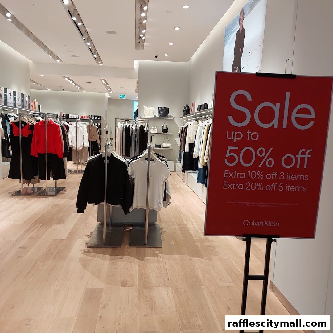 Calvin Klein store interior with a prominent sale sign and clothing displays.