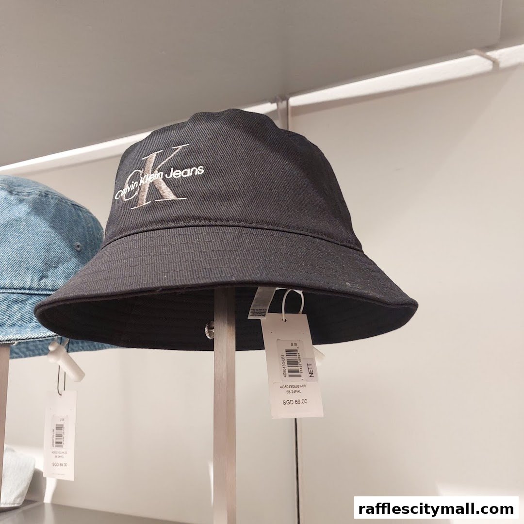 A black Calvin Klein bucket hat with the brand logo displayed prominently.