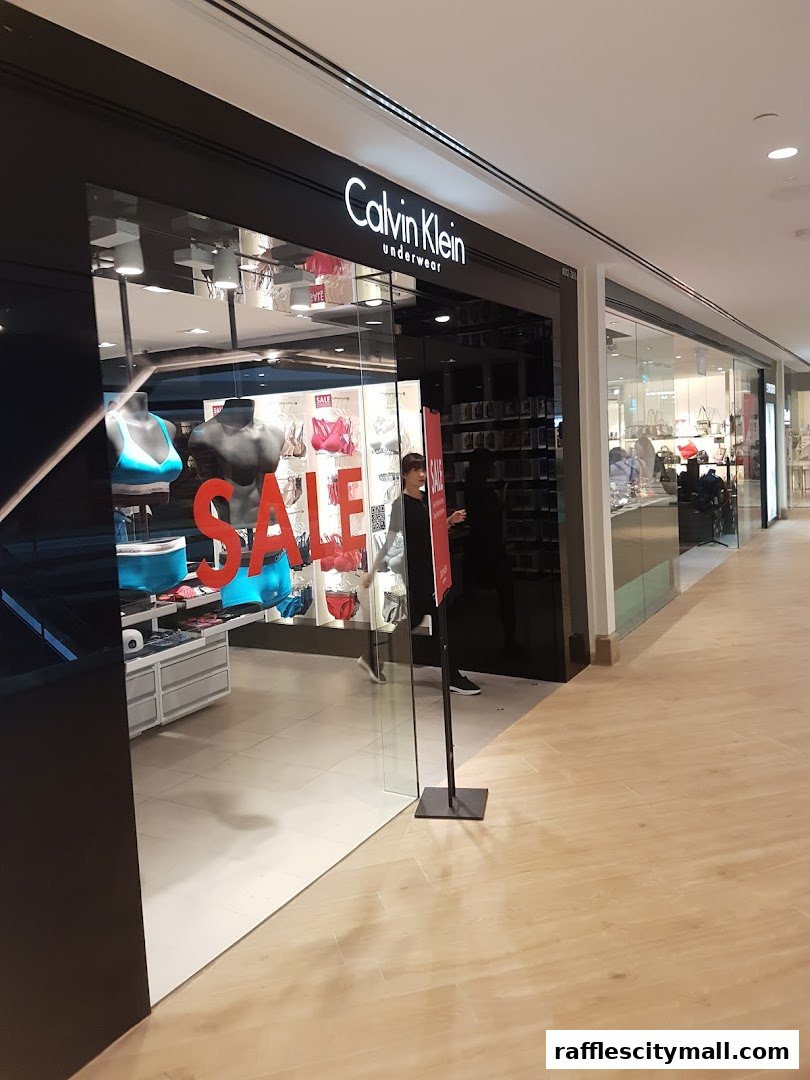 Calvin Klein Underwear shop front with mannequins and sale signage.