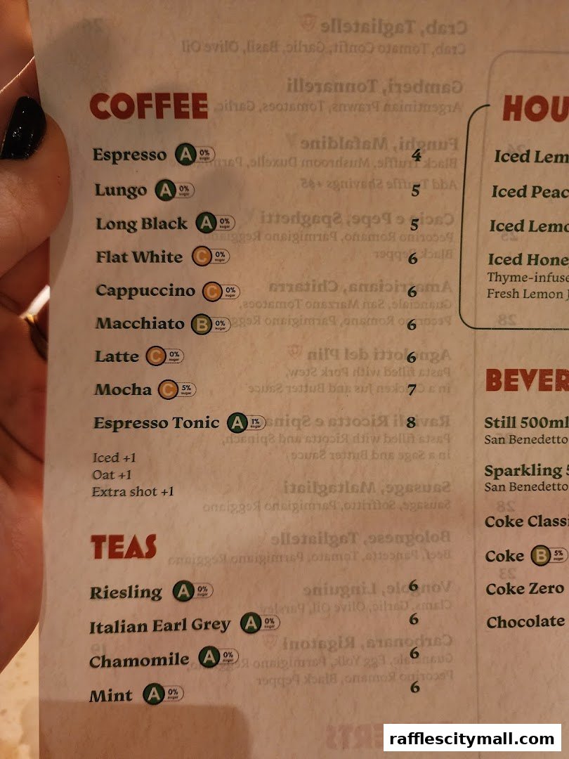 A close-up view of a menu featuring coffee and tea selections with sugar content indicators.