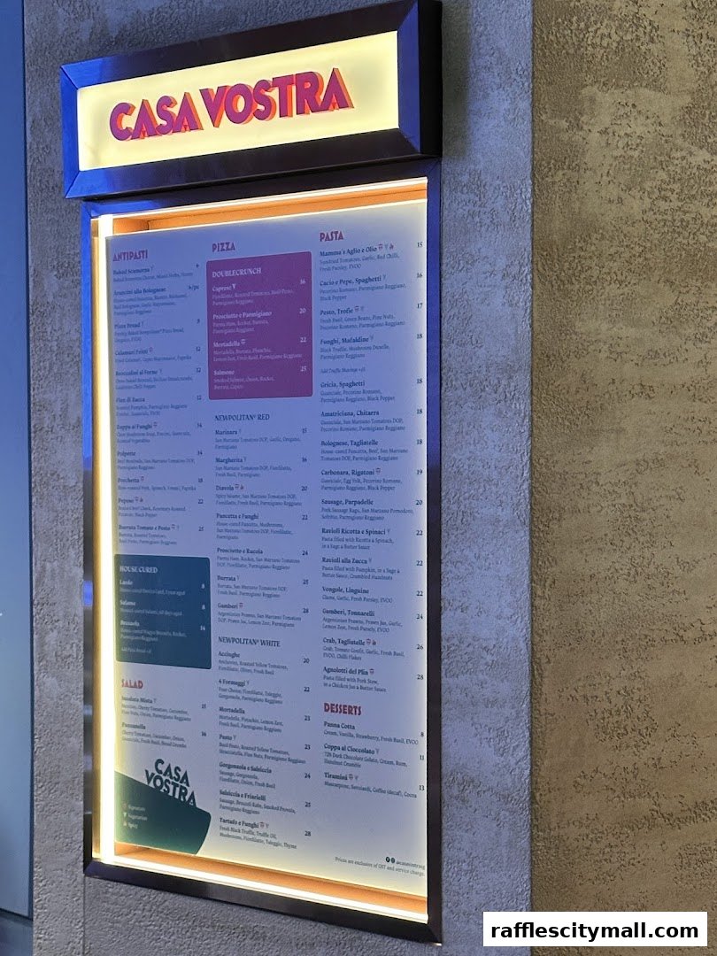 A brightly lit menu board for Casa Vostra, showcasing pizzas, pastas, antipasti, salads, and desserts.