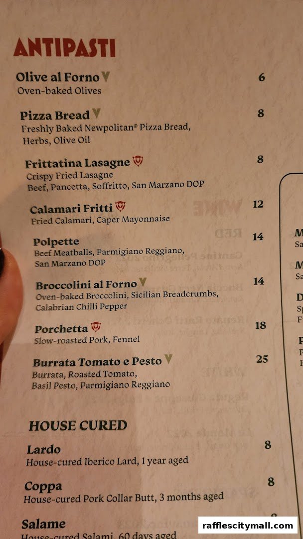 A close-up of a menu featuring Italian antipasti and house-cured items with prices.