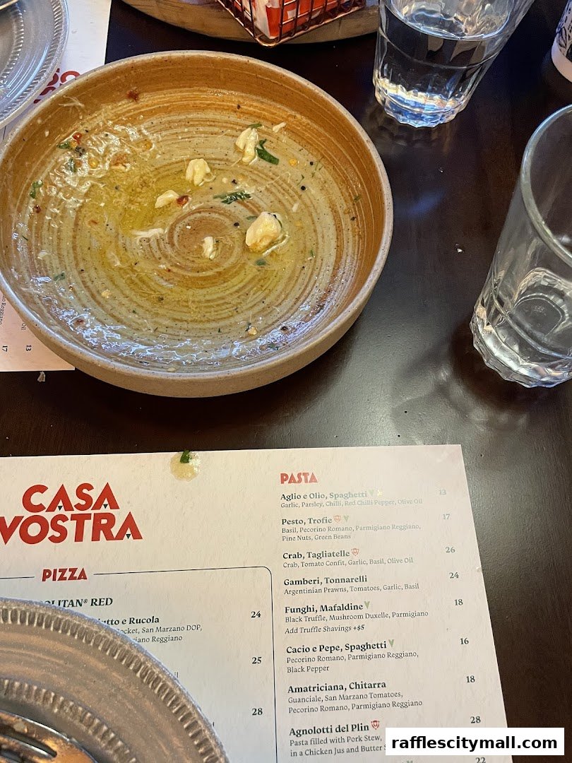 A partially eaten meal with a menu from Casa Vostra restaurant on the table.