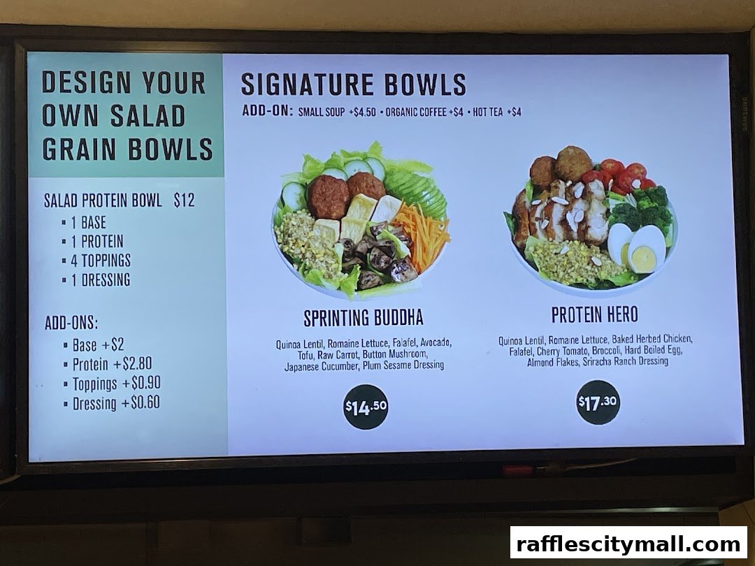 A digital menu board displaying signature salad and grain bowls with ingredients and prices.