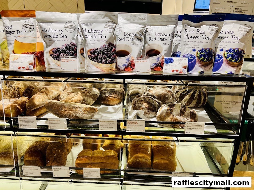 A display case filled with various artisanal breads and packaged teas from Cedele Bakery Kitchen.