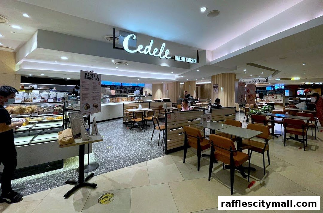 Interior view of Cedele Bakery Kitchen with seating, display cases, and a menu board.