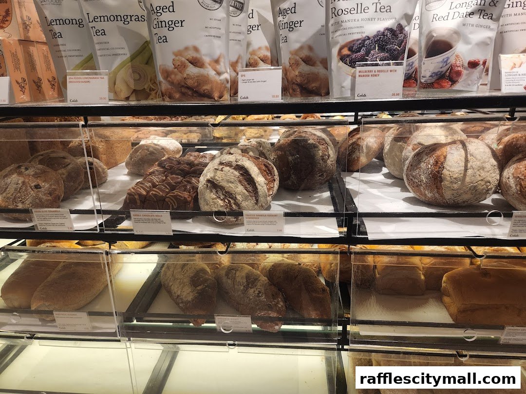 A display of freshly baked bread and packaged teas at Cedele Bakery Kitchen.