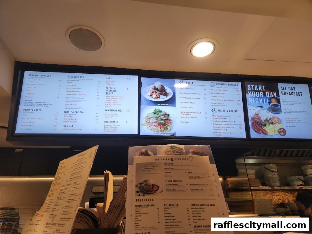 A digital menu board displaying various food and drink options at Cedele Bakery Kitchen.