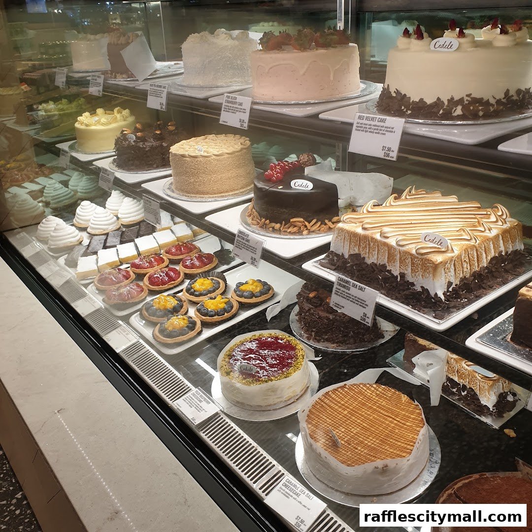 A display case filled with various cakes and pastries from Cedele Bakery Kitchen.