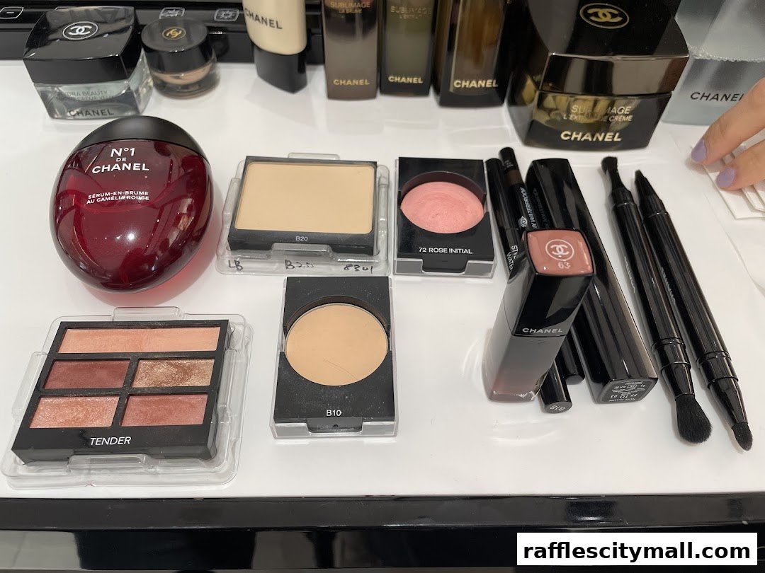 A collection of Chanel beauty products including serums, powders, eyeshadows, and lipsticks.