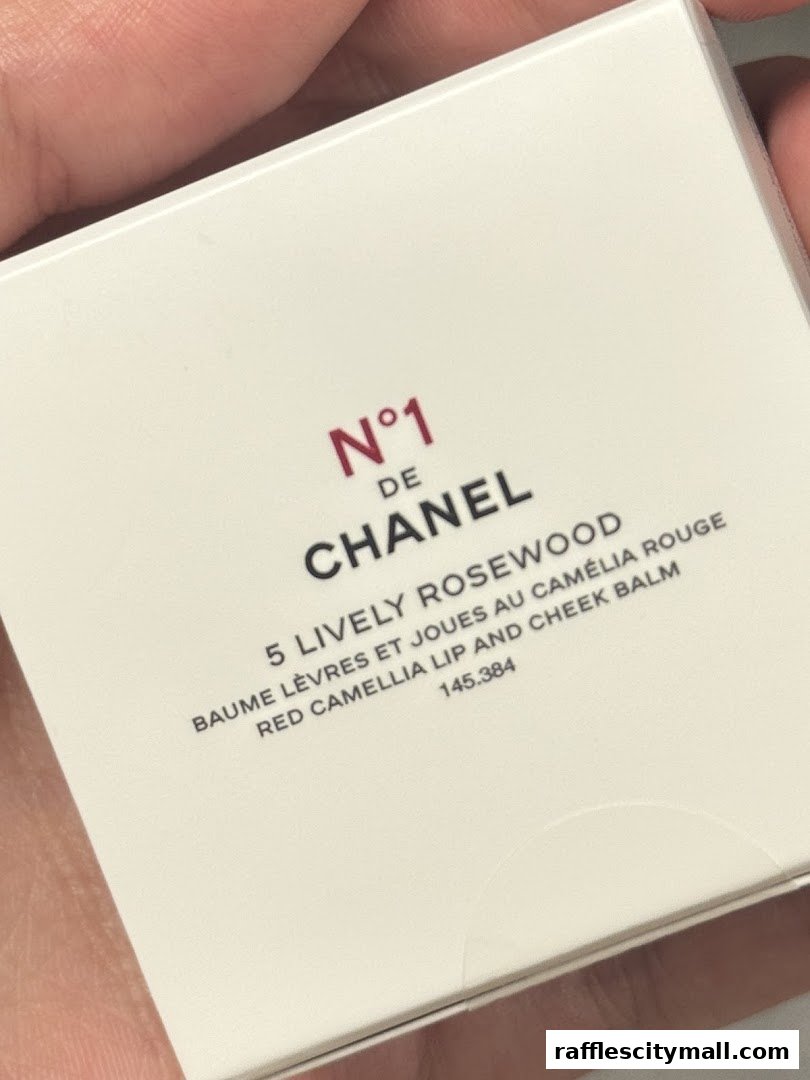 A close-up of a Chanel N°1 Red Camellia Lip and Cheek Balm packaging.