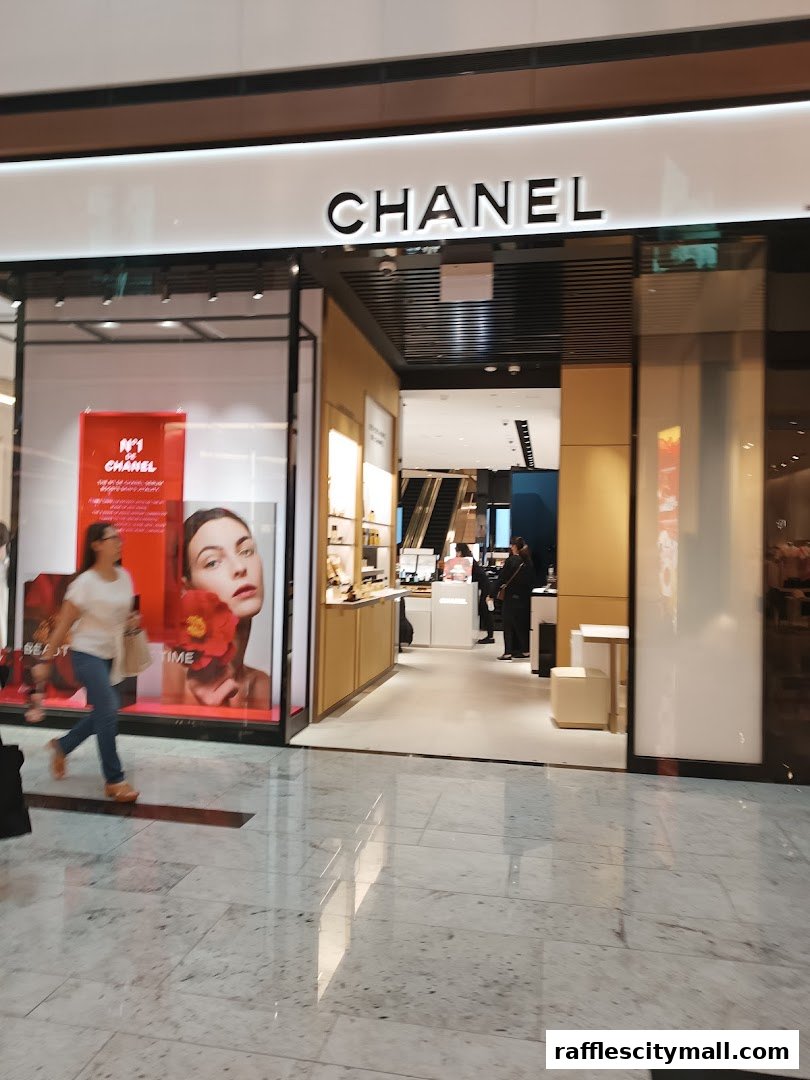 The exterior of a Chanel store with its iconic logo and a display window.