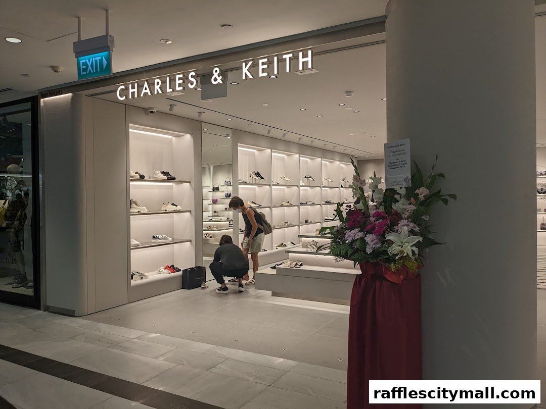 The entrance of a Charles & Keith shoe store with shoes displayed on shelves and two customers browsing.