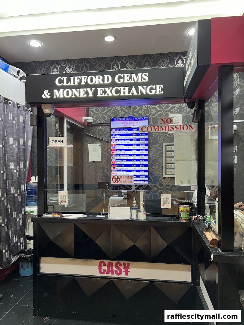 A money exchange counter with currency rates displayed on a screen and 'No Commission' signage.