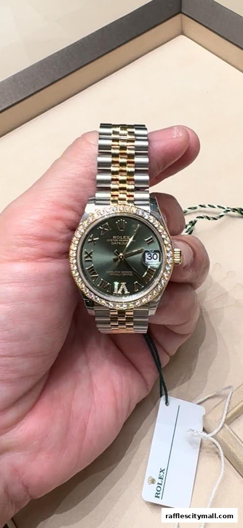 A hand holds a luxurious Rolex watch with a two-tone band and diamond bezel.