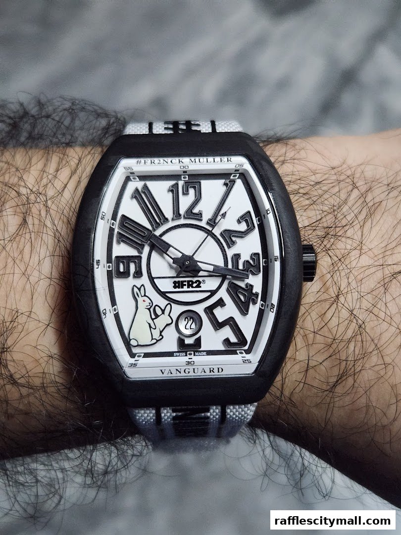 A close-up shot of a Franck Muller Vanguard watch with a white dial and a rabbit motif on a person's wrist.
