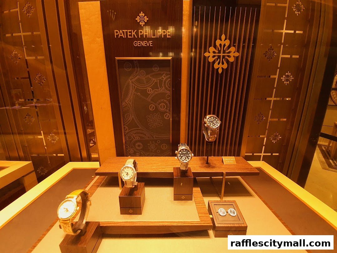 A luxury watch display featuring Patek Philippe timepieces and cufflinks in a well-lit store window.