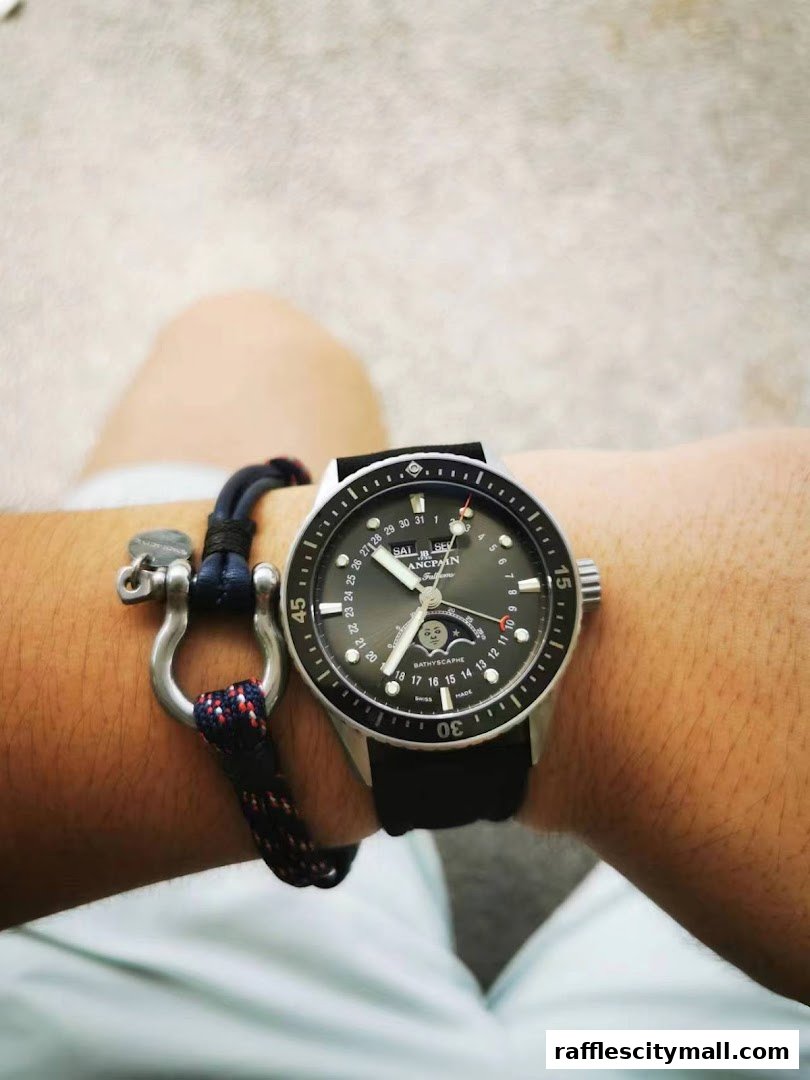 A close-up shot of a person's wrist wearing a luxury watch and a bracelet.