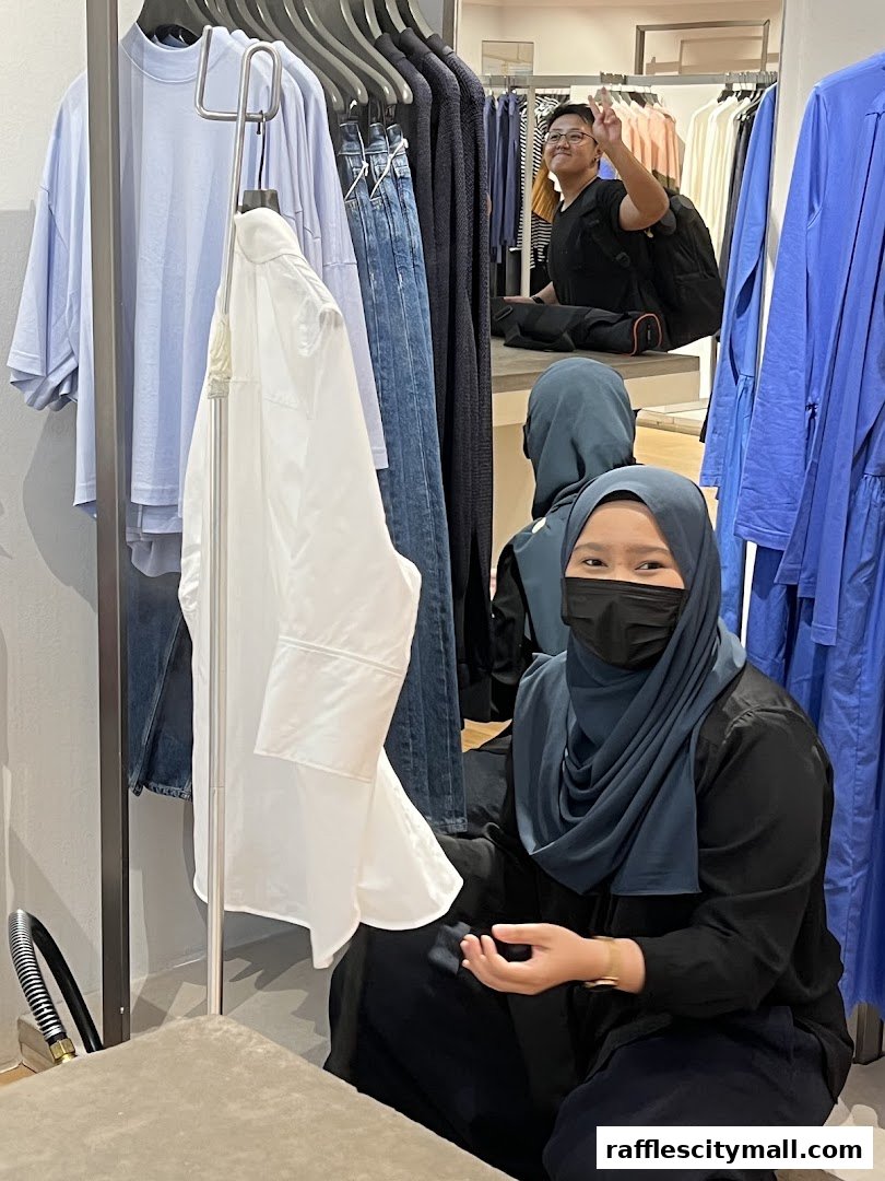 Two women are in a clothing store, surrounded by racks of stylish apparel.
