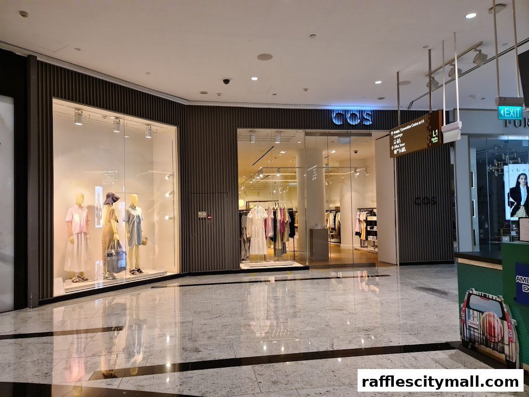 The COS store entrance with mannequins in the window and clothing displays inside.