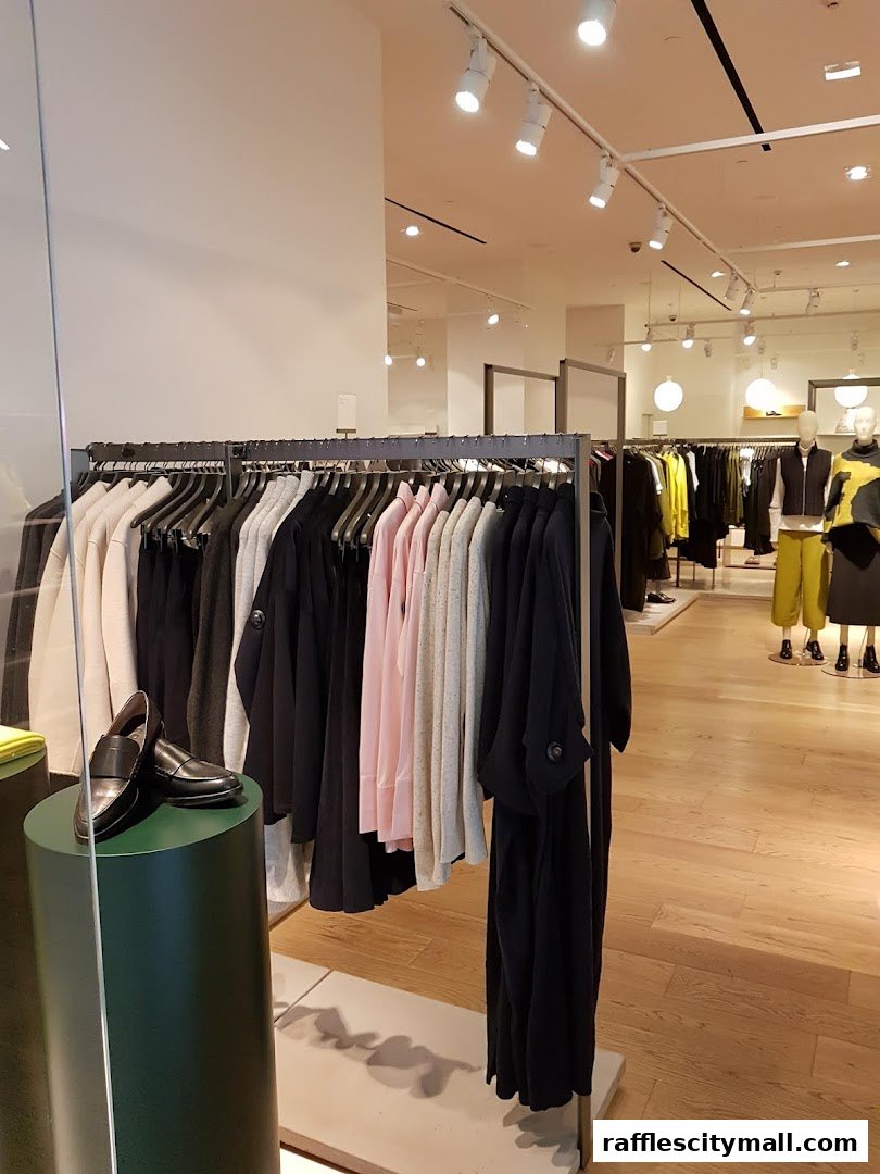 A well-lit clothing store interior with racks of stylish apparel and mannequins.