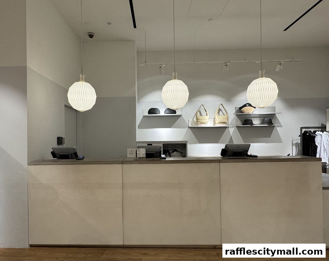 The interior of a COS store showing a clean, modern checkout counter with display shelves.