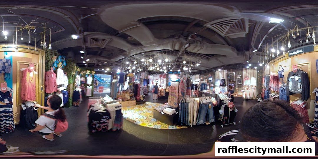 Interior view of a brightly lit Desigual clothing store with racks of colorful apparel and mannequins.