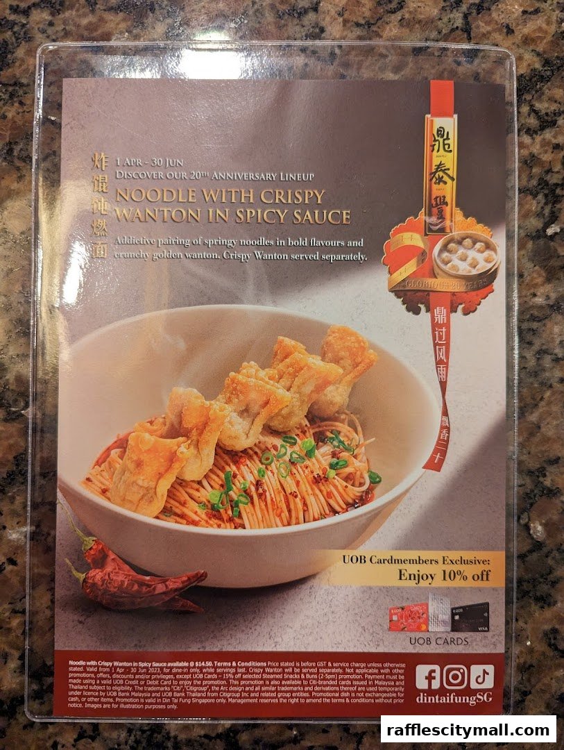 A menu item featuring noodles with crispy wontons in spicy sauce, with a special offer.