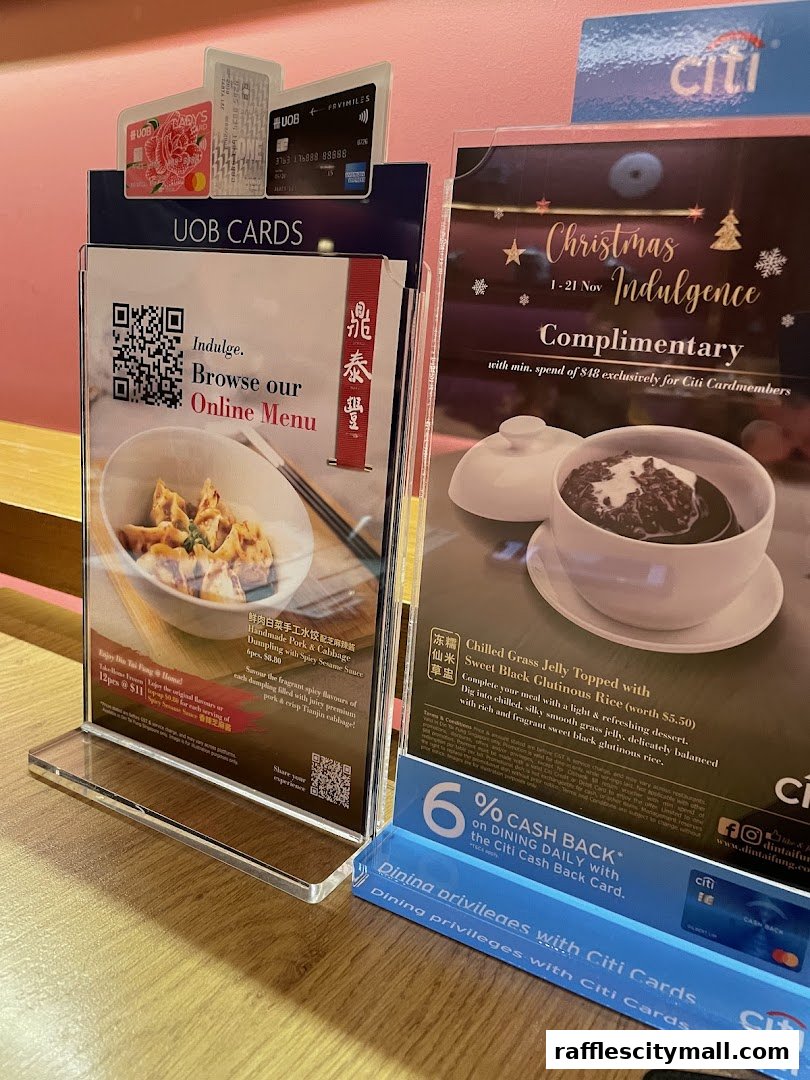 Promotional displays for Din Tai Fung, featuring UOB cards and a Christmas indulgence offer.