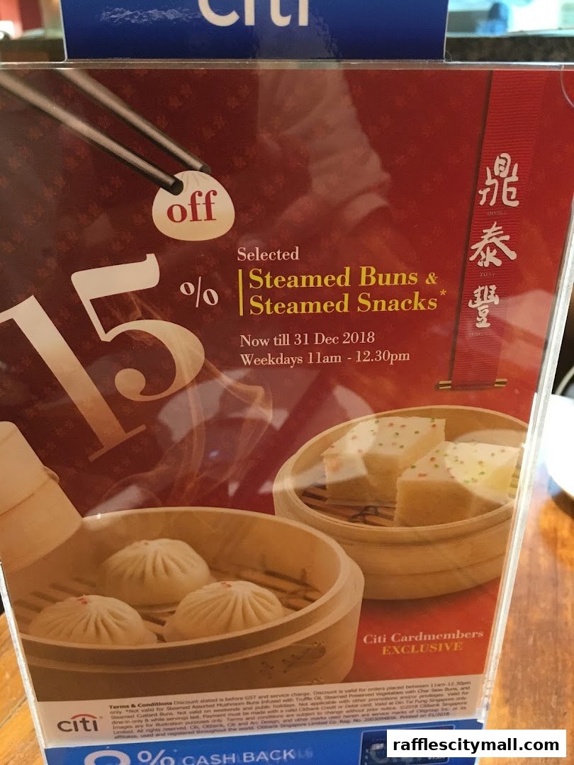 A promotional flyer offering 15% off selected steamed buns and snacks at Din Tai Fung.