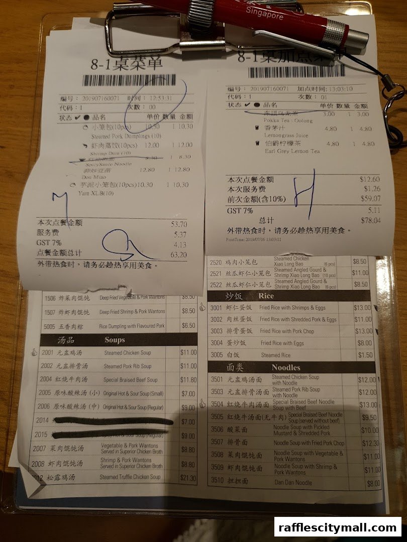A close-up of a restaurant bill with various food and drink items listed with prices.