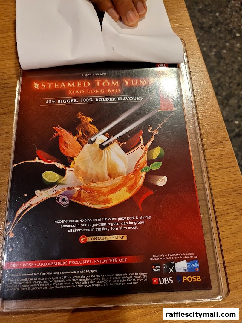 A menu featuring Steamed Tom Yum Xiao Long Bao with a special offer for cardmembers.