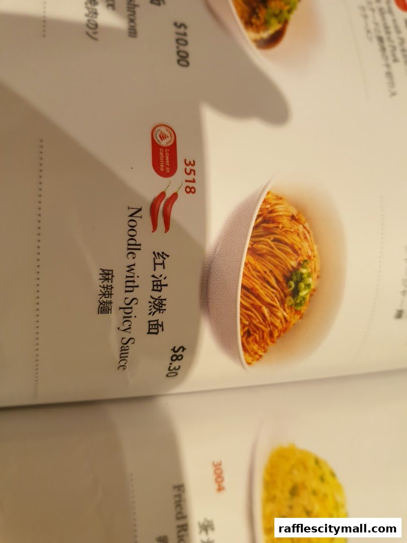A menu page from Din Tai Fung featuring 'Noodle with Spicy Sauce' and 'Fried Rice'.