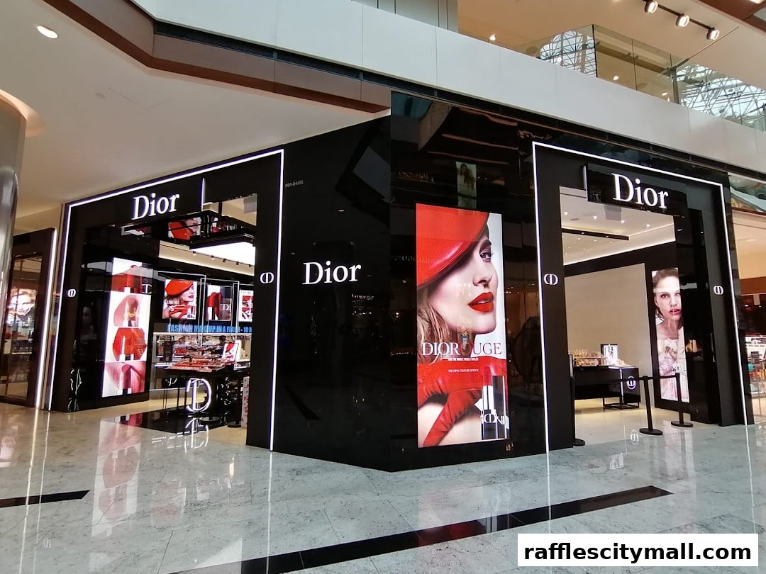 The Dior Beauty boutique at Raffles City features a sleek, modern design with illuminated displays showcasing makeup.