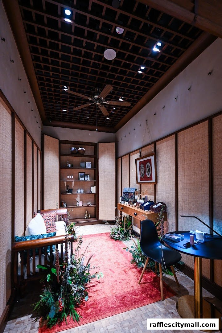 Interior of a Diptyque store with shelves of products, seating, and decorative plants.