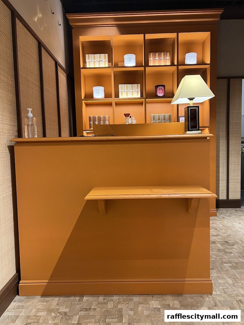 A well-lit counter and display shelves filled with Diptyque products.