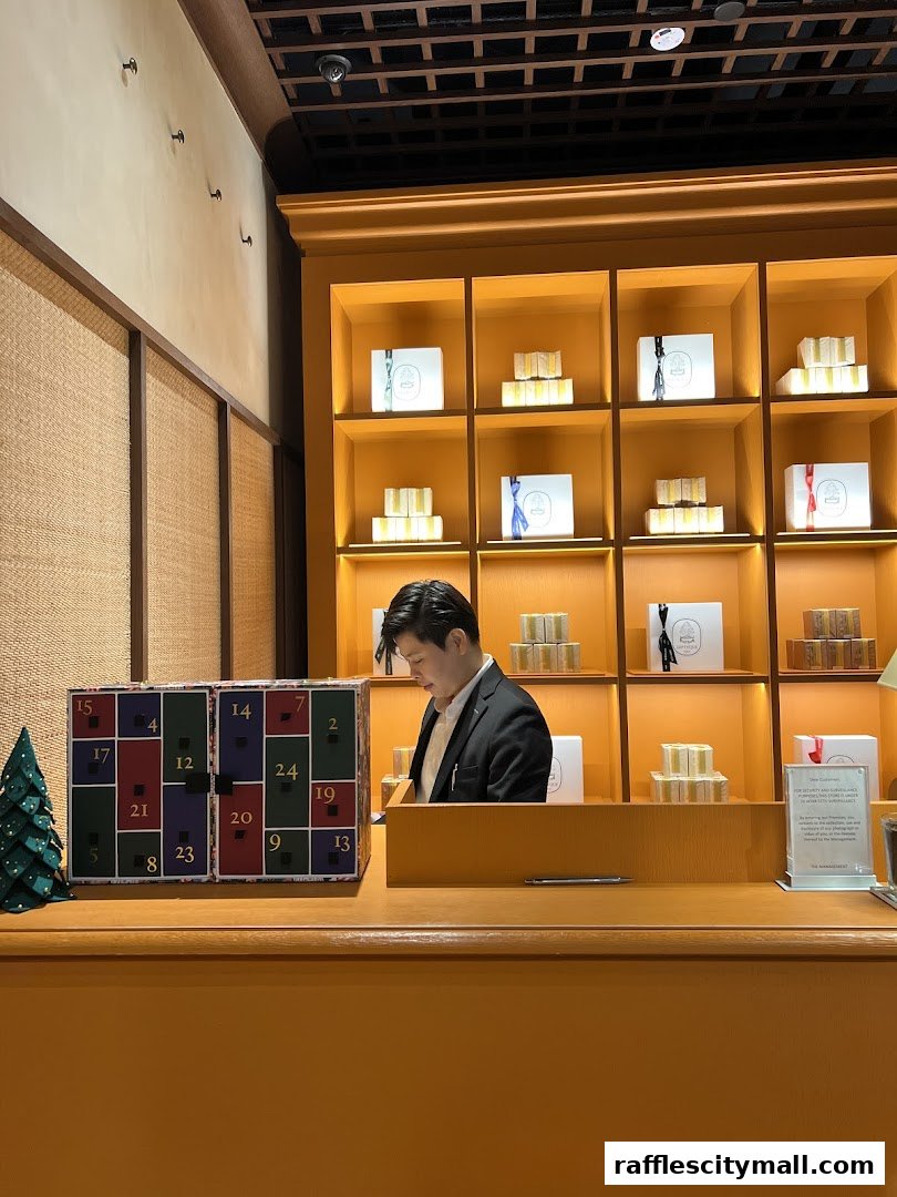 A man in a suit stands behind a counter with an advent calendar and shelves of products.