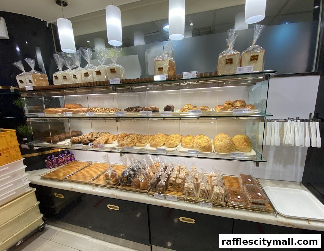 A display of freshly baked bread and pastries in a modern bakery setting.