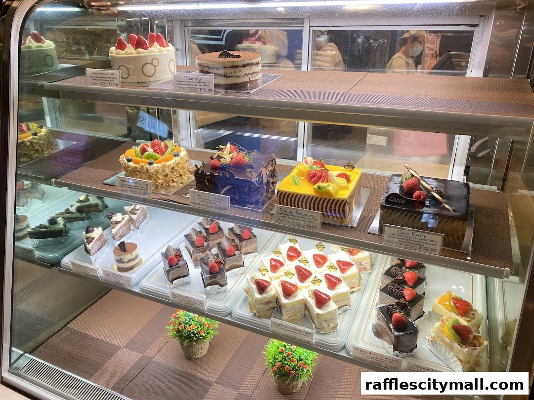 A display case filled with a variety of beautifully decorated cakes and pastries.