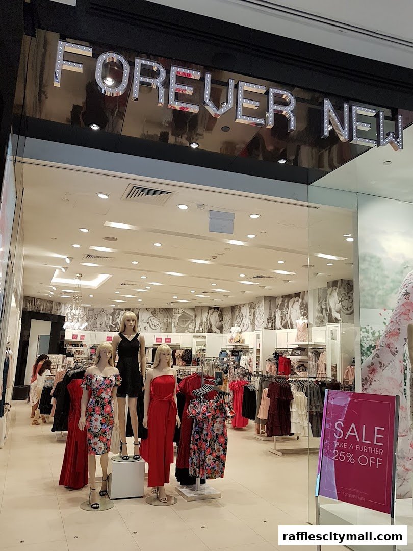 The entrance of a Forever New clothing store with mannequins displaying dresses and a sale sign.