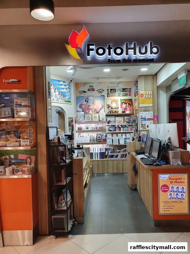 The entrance to FotoHub, a photography shop, displaying various photo products and services.