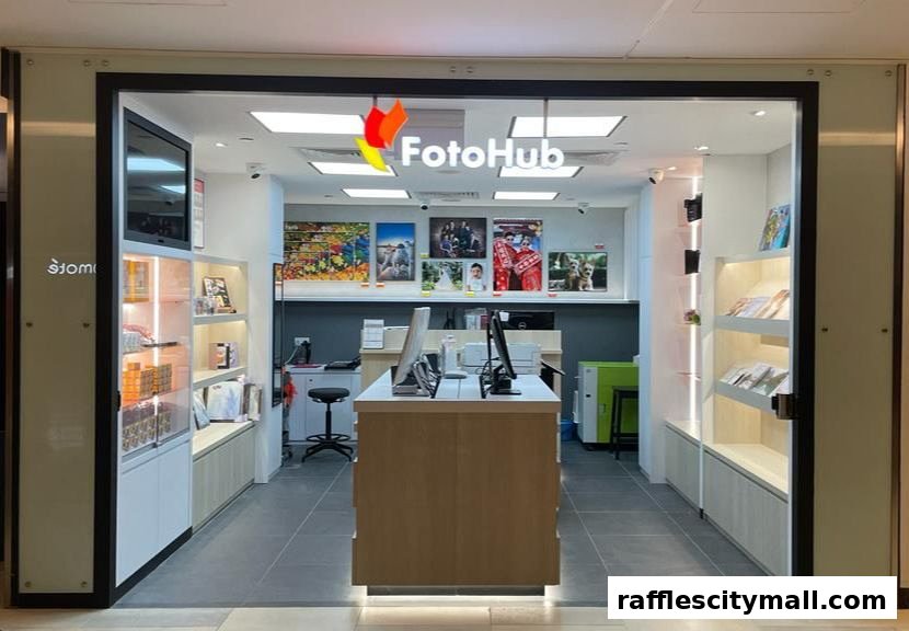 The entrance of FotoHub Raffles City, showcasing photography services and products.