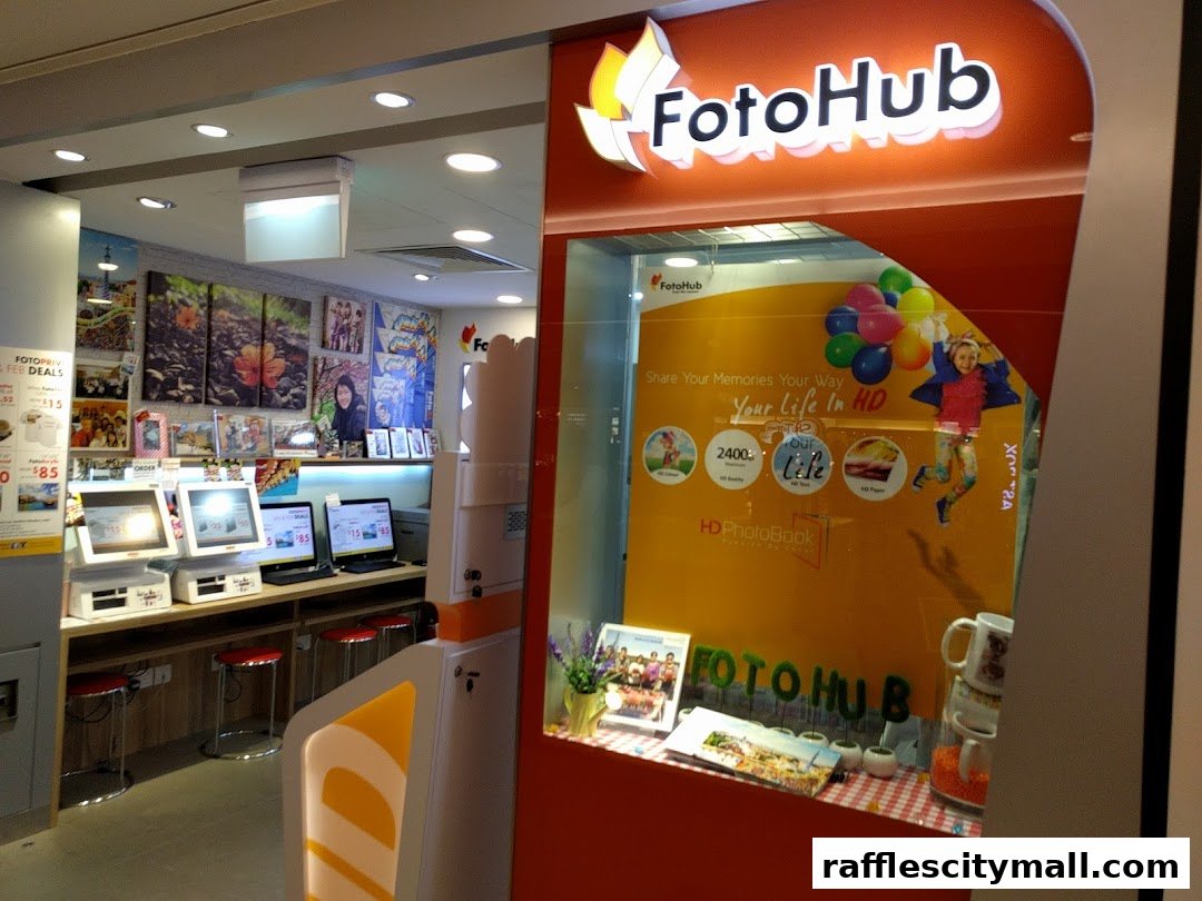 FotoHub Raffles City shop front with promotional displays and self-service kiosks.