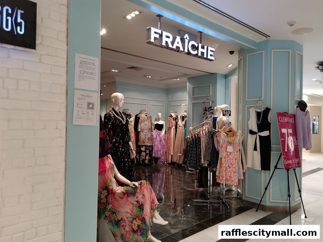 Fraiche Raffles City shop front with mannequins displaying dresses and a clearance sale sign.