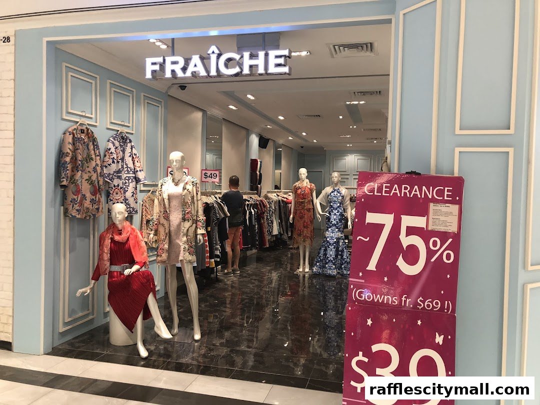 The entrance of Fraiche Raffles City, showcasing mannequins with stylish outfits and a clearance sale sign.